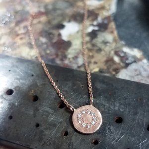 Gold necklace. 14k rose gold necklace with a coin pendant & 0.08ct diamonds.